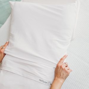 A NurtueOne pillow cover on a nurtureone nesting pillow