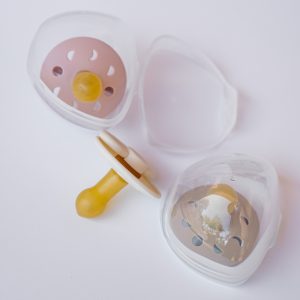 A dummy case with three frigg pacifiers